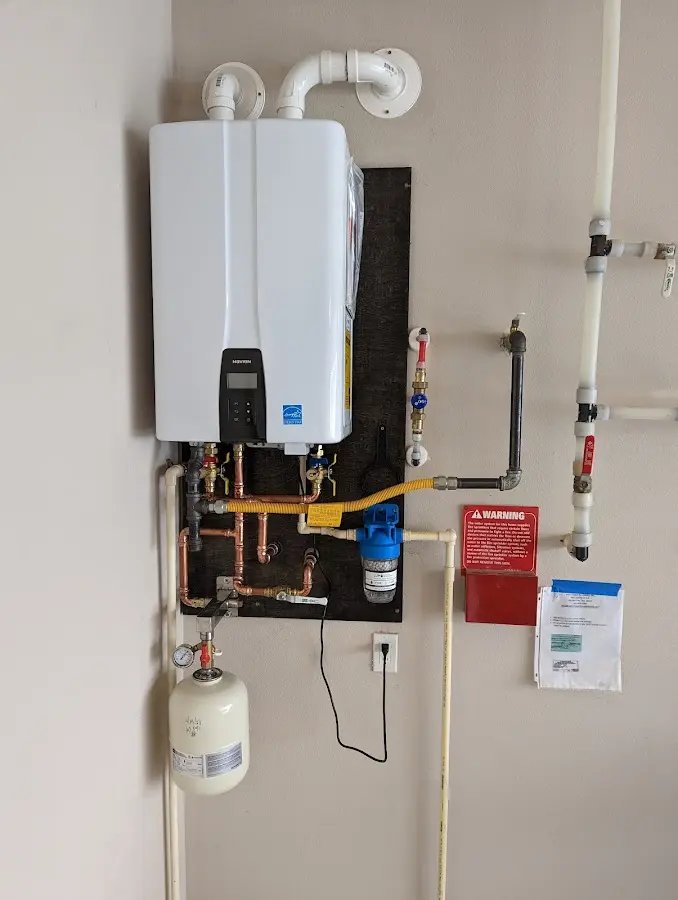 Professional plumber installing copper piping in a Narberth home